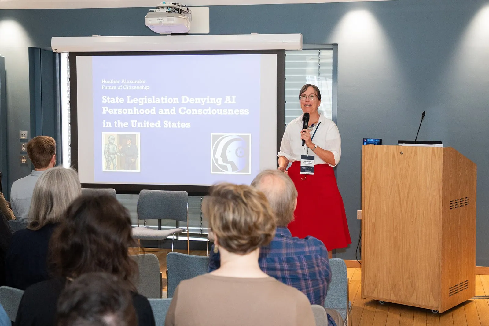 Heather Alexander presenting on state legislation denying AI personhood, with the lab logo on screen